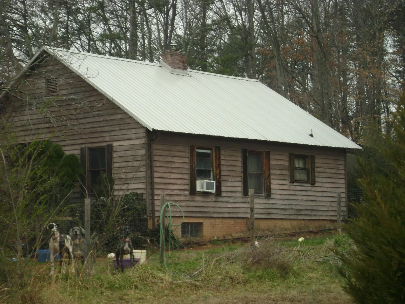 White metal roof on an old wood sided farmhouse, from a Metal Roof Installation job in Liscomb